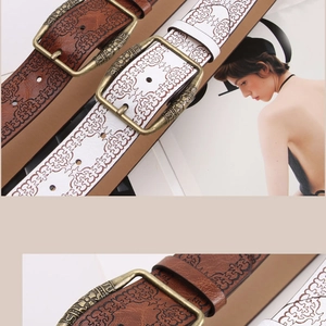 Detailed view of vintage embossed bronze buckles and floral patterns on two retro belts