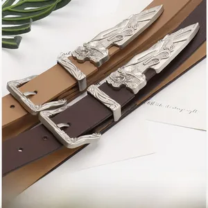 Detail of western vintage carved buckles on light and dark brown leather belts
