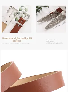 Macro shot of western retro engraved metal buckles on white and brown PU leather belts