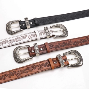 Vintage western embossed leather belts with floral patterns and carved silver buckles