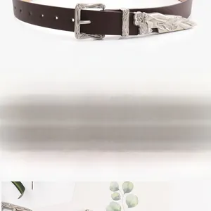 Detail of coffee brown western belt with engraved silver buckle and metal tip set