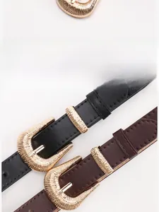 Detail of vintage metal pin buckles in gold finish on black and brown slim leather belts