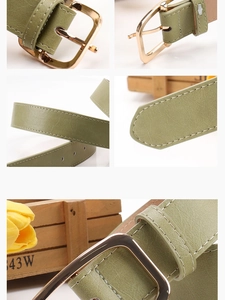Detailed macro view of dark green leather belt with gold pin buckle and fine stitching