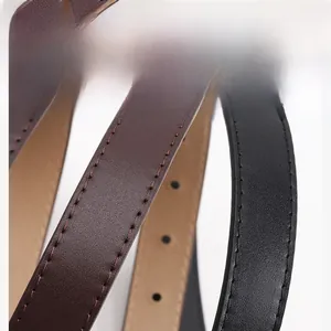 Close-up of vintage brown and black PU leather belts showing texture and stitching details
