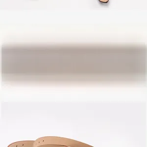 Detailed view of light brown leather slim belt with metal eyelets and fine stitching