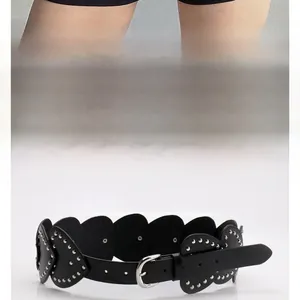 Detailed view of black Y2K leather belt featuring heart-shaped studs and silver buckle