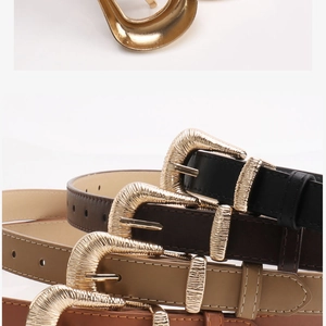 Detail of vintage metal buckles and white stitching on multiple slim leather belts