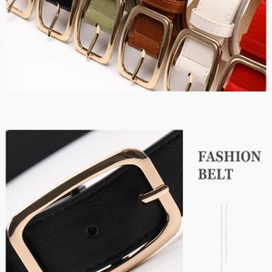 Detailed macro view of black faux leather belt with textured finish and gold square buckle