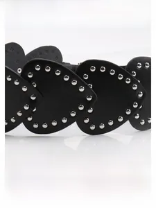 Detailed close-up of Y2K heart-shaped PU leather belt with silver metal rivet studs