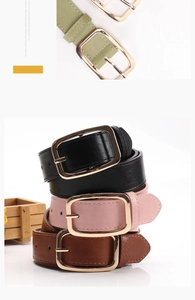 Close-up of minimalist colorful belts with elegant golden square buckles for women