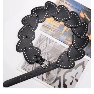 Detail view of black heart-shaped PU leather belt with silver studded rivets and metal buckle