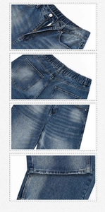 Dettaglio dei jeans blu vintage che mostrano il bottone in vita e la trama del tessuto