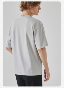 Rear view of loose-fit men's crewneck cotton T-shirt in minimalist light grey color
