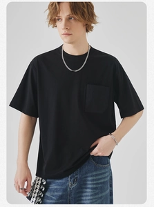 Detail of black cotton T-shirt featuring a classic crew neck and a square chest pocket