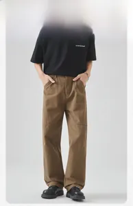 Detail shot of brown cotton cargo pants showing loose straight fit and knee stitching