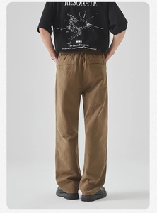 Rear view of men's brown straight-leg trousers with elastic waist and back pockets