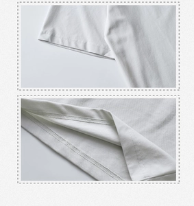 Detailed view of the double-needle stitching on the white cotton T-shirt sleeve and hem