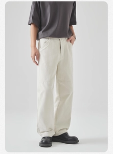 Detail shot of men's cream-colored pique cotton straight leg cargo pants with knee stitching
