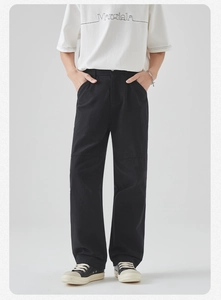 Detailed view of black loose fit cargo pants with knee seam stitching for men