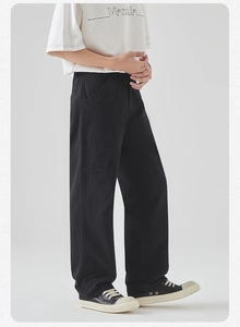 Detail view of black cargo pants featuring side pockets and a straight-leg cotton fit