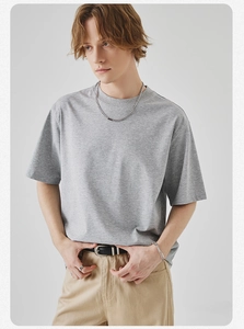 Detailed texture of grey crew neck t-shirt with loose fit design and soft cotton fabric