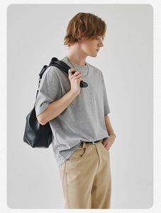 Detail of heather grey cotton t-shirt showing side drape and relaxed fit texture