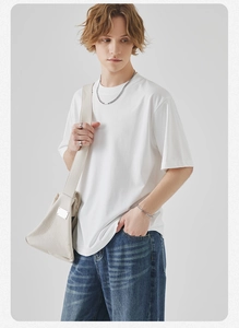 Detail of premium heavy cotton white t-shirt texture and minimalist crew neck stitching