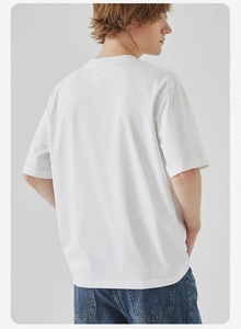Rear view of a loose-fit white crew neck T-shirt showing fine stitching and knit texture