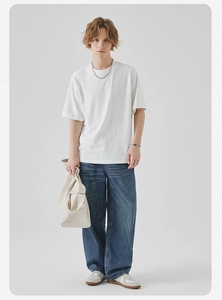 Men casual outfit featuring white basic short sleeve T-shirt and wide-leg denim jeans