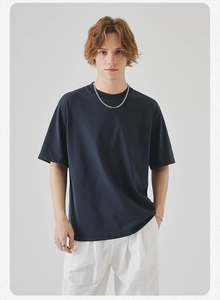 Detail of navy blue oversized cotton T-shirt featuring dropped shoulder and crew neck