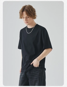 Detail of a minimalist black crew neck short sleeve T-shirt with premium texture fabric