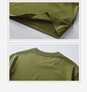 Detail of olive green t-shirt showing double-stitched hem and reinforced collar rivet