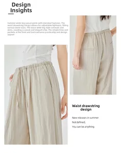 Detail view of high-waist drawstring and vertical texture on beige wide-leg pants