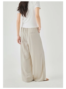 Rear view of oatmeal wide-leg trousers featuring elastic waist and minimal back pocket detail
