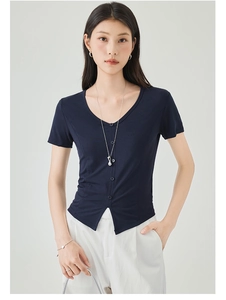 Detail view of the V-neck button-up short sleeve slim top with waist pleat texture