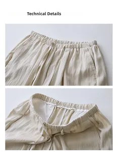 Detail of loose beige trousers showing drawstring waist, side pockets and quality stitching