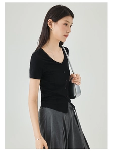 Close-up of black slim fit short sleeve T-shirt with front button detail and soft fabric