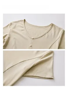 Detail view of V-neck knit top showing neat stitching and decorative buttons