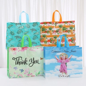 Close-up of printed non-woven shopping bags with reinforced handles in four patterns