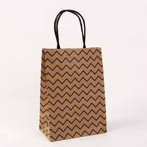 Detail of kraft paper bag featuring black zigzag patterns and sturdy twisted rope handles