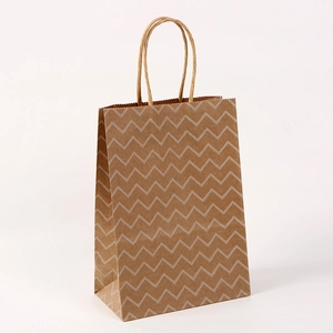 Close-up of brown kraft paper bag with white wavy patterns and twisted rope handles