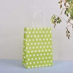 Eco-friendly light green paper gift bag with white polka dots and twisted handles