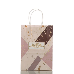 Pink and brown marble pattern kraft gift bag with gold foil details and rose design