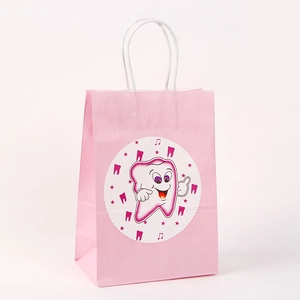 Detailed view of pink paper gift bag with white twisted handles and cute tooth cartoon