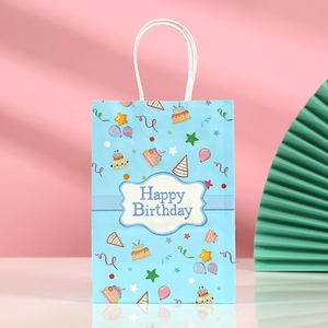 Detail showing blue kraft paper birthday gift bag with Happy Birthday cartoon print