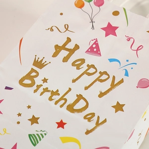 White birthday paper gift bag with Happy Birthday text and colorful party elements
