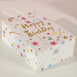 White birthday gift paper bag with gold Happy Birthday text and colorful party patterns