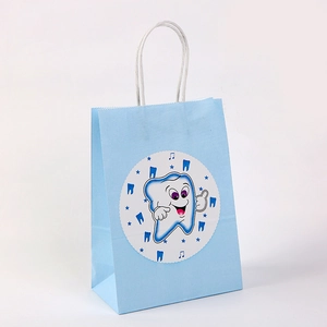 Light blue paper gift bag with cute cartoon tooth design and white rope handles