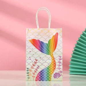 Detail view of mermaid party gift bag with fish scale pattern and white rope handle