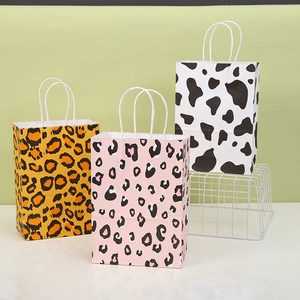 Detailed view of animal print kraft paper gift bags with sturdy white rope handles